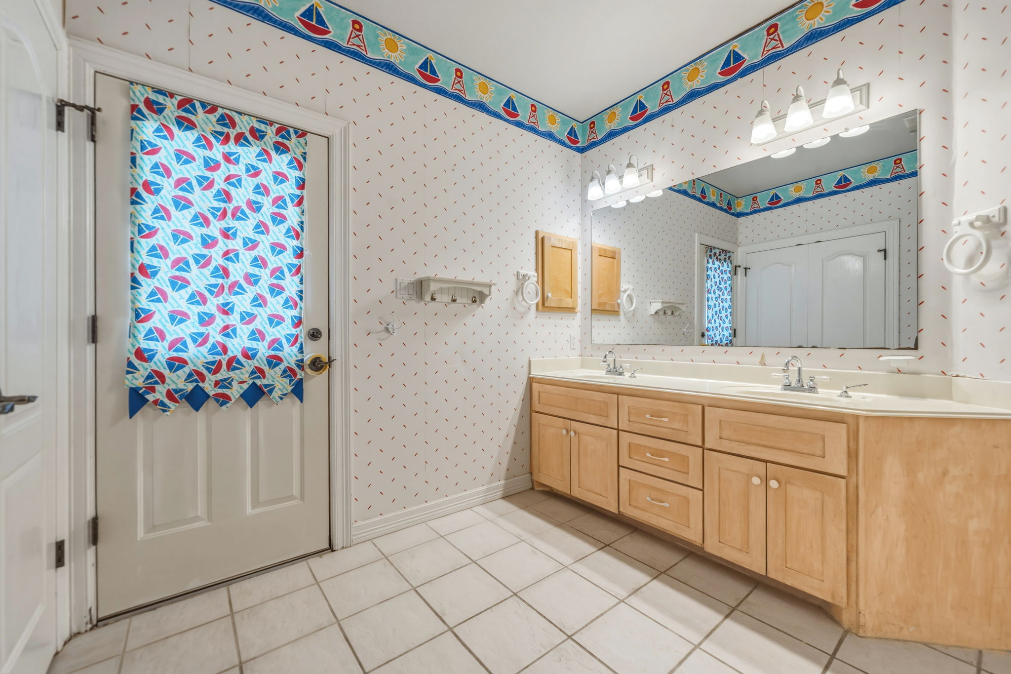 14039 Timberline Trail Austin, TX 78737 - Photo 34 of 39 Bathroom with double vanity, light tile patterned floors, and wallpapered walls