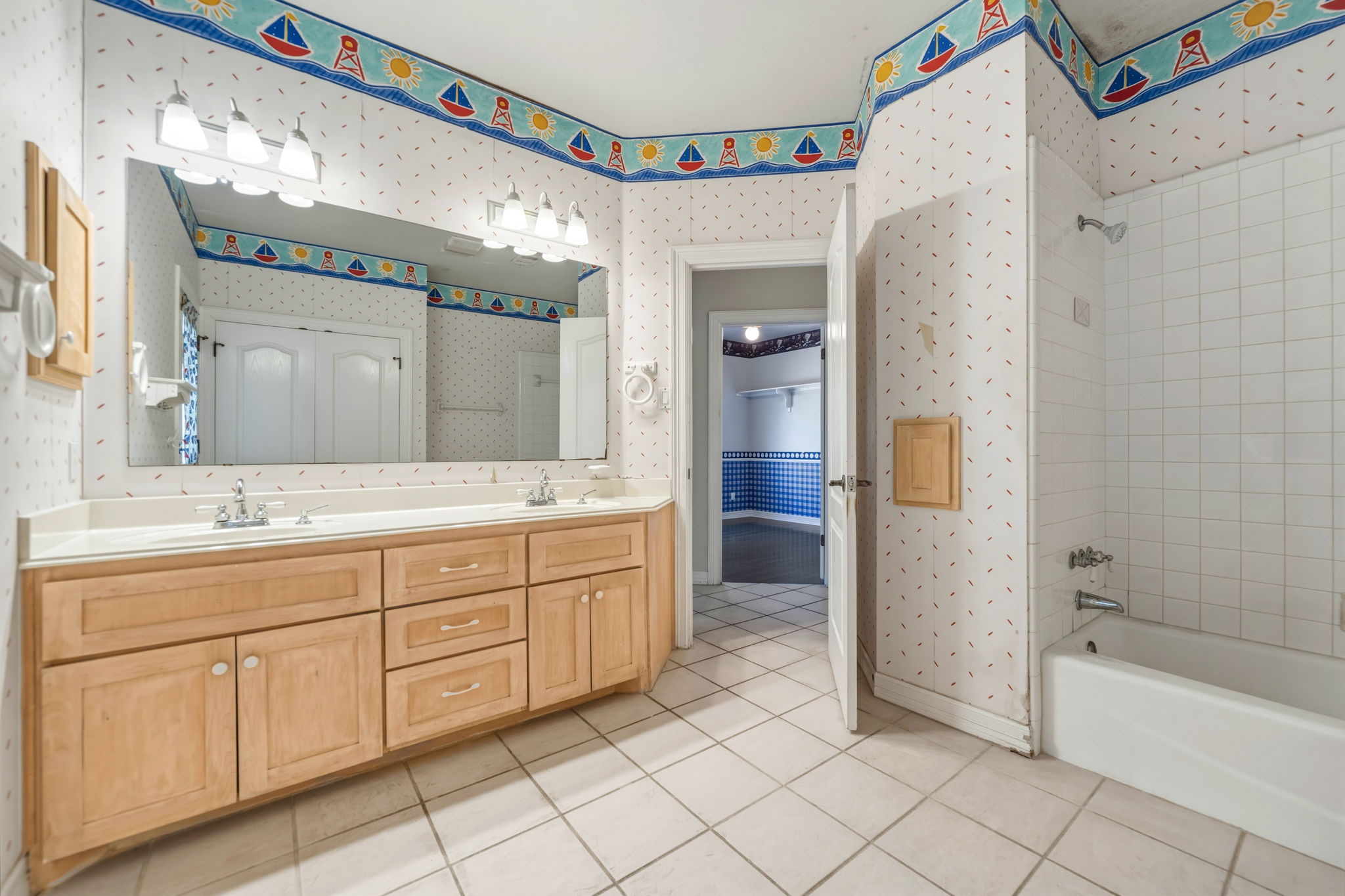 14039 Timberline Trail Austin, TX 78737 - Photo 35 of 39 Full bath with wallpapered walls, double vanity, light tile patterned floors, and shower / washtub combination