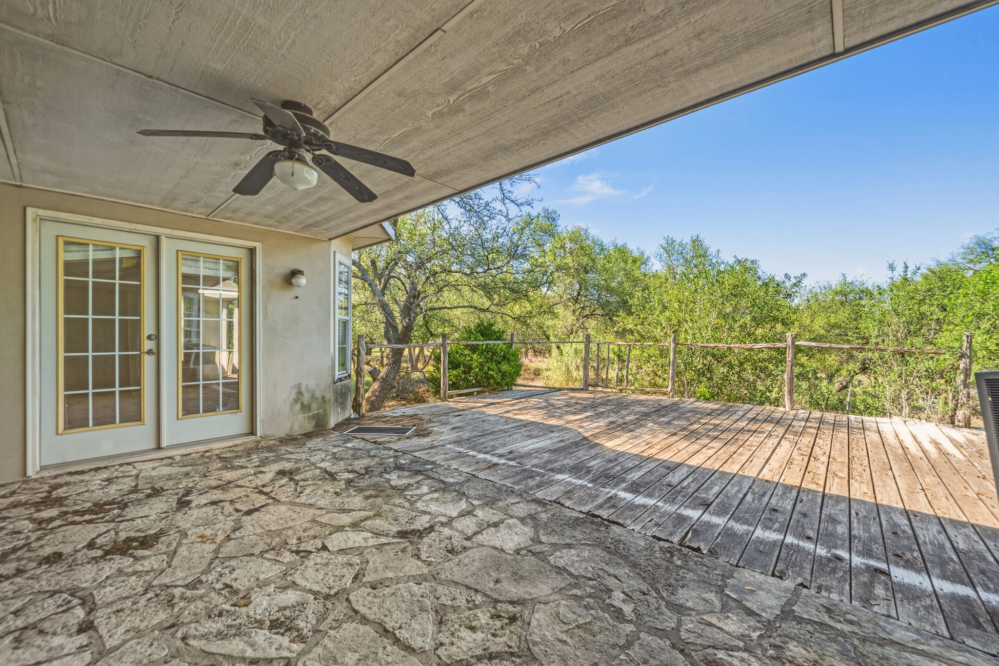14039 Timberline Trail Austin, TX 78737 - Photo 37 of 39 Deck with ceiling fan and french doors