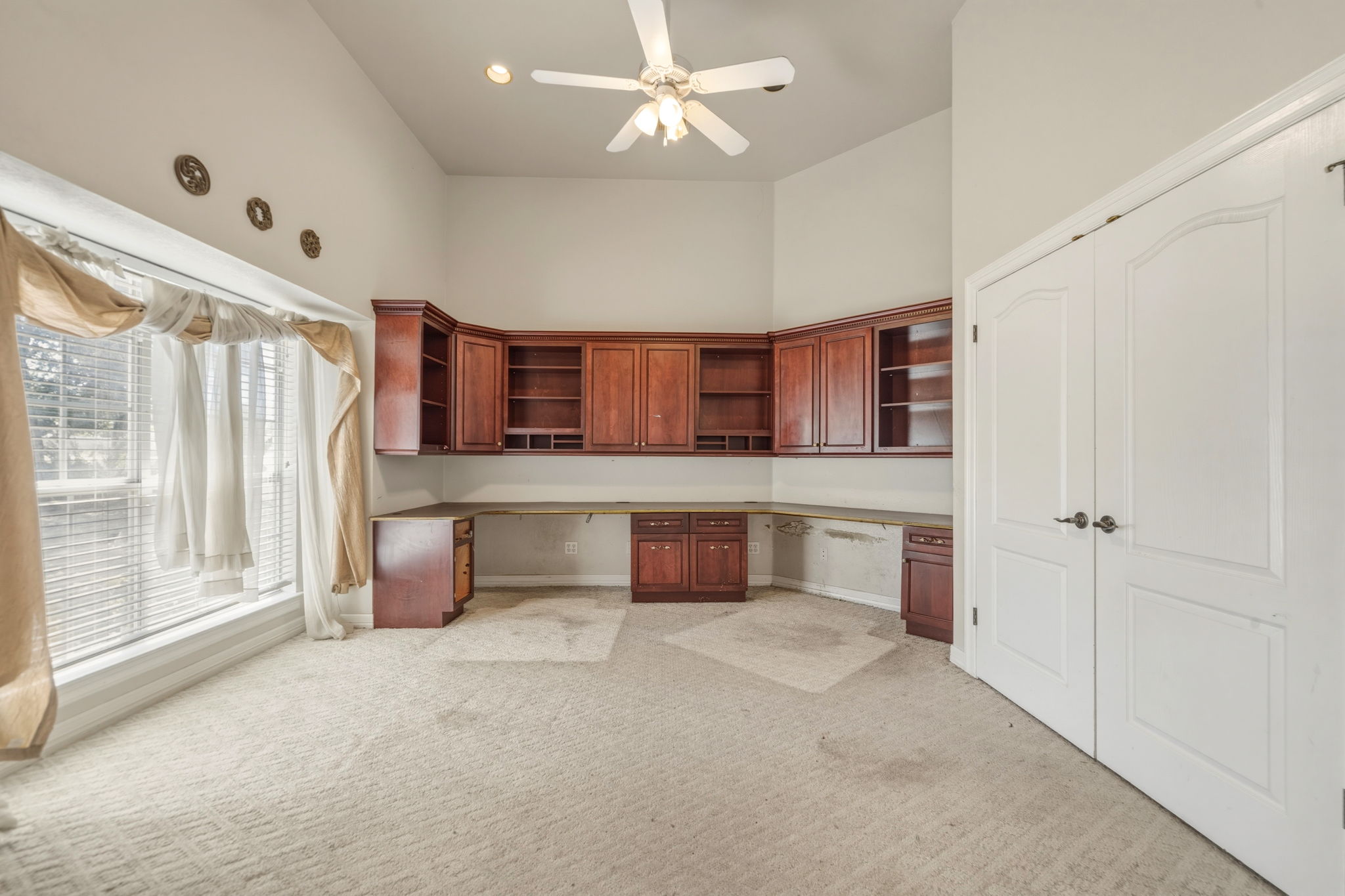 14039 Timberline Trail Austin, TX 78737 - Photo 7 of 39 Unfurnished office with built in desk, a high ceiling, light carpet, and a ceiling fan