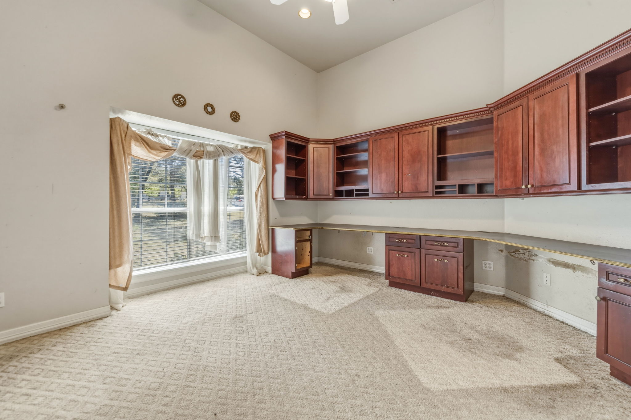 14039 Timberline Trail Austin, TX 78737 - Photo 8 of 39 Unfurnished office with built in desk, a high ceiling, light carpet, and a ceiling fan