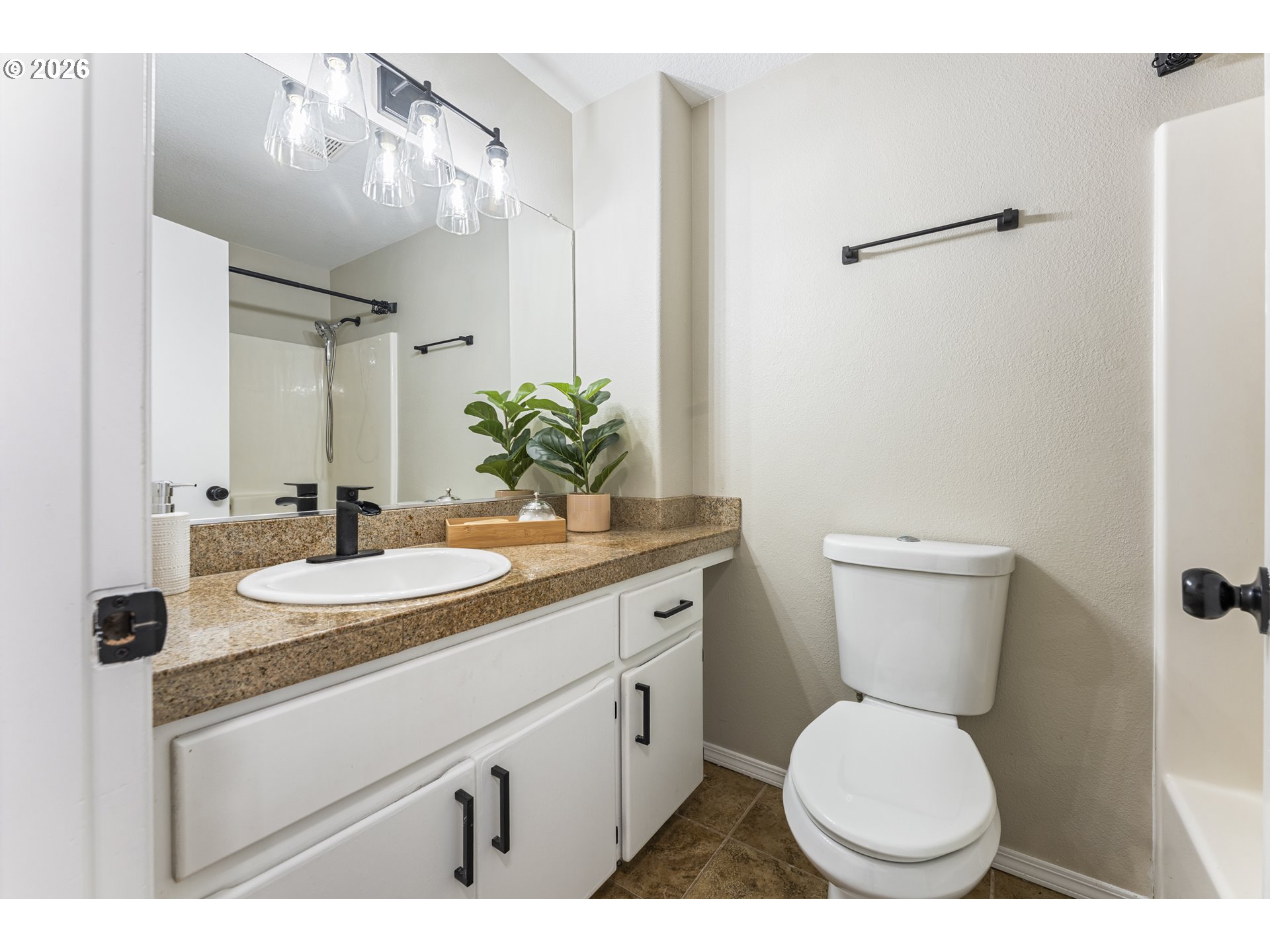 4024 Southeast 154th Place Portland, OR 97236 - Photo 19 of 43 a bathroom with a granite countertop toilet sink and mirror
