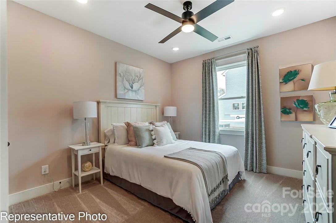 109 Old Fld Road Statesville, NC 28677 - Photo 13 of 37 a bedroom with a large bed and a chandelier