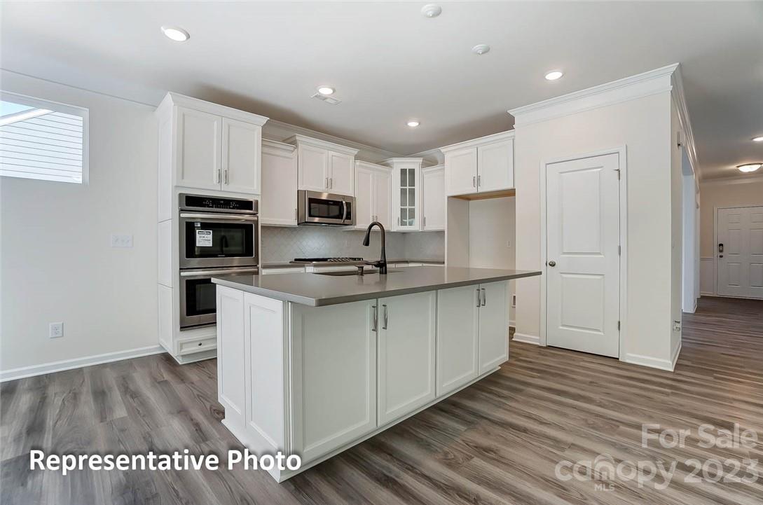 109 Old Fld Road Statesville, NC 28677 - Photo 19 of 37 a kitchen with kitchen island white cabinets and stainless steel appliances