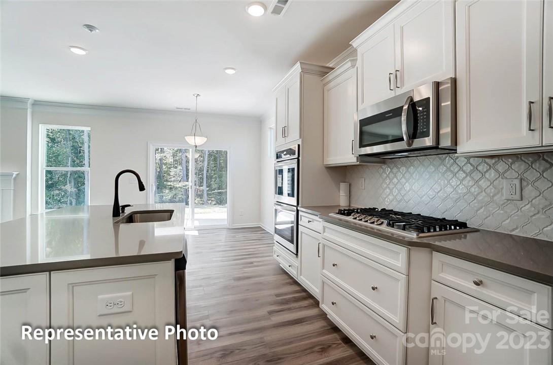 109 Old Fld Road Statesville, NC 28677 - Photo 20 of 37 a kitchen with stainless steel appliances granite countertop a stove a sink and a microwave