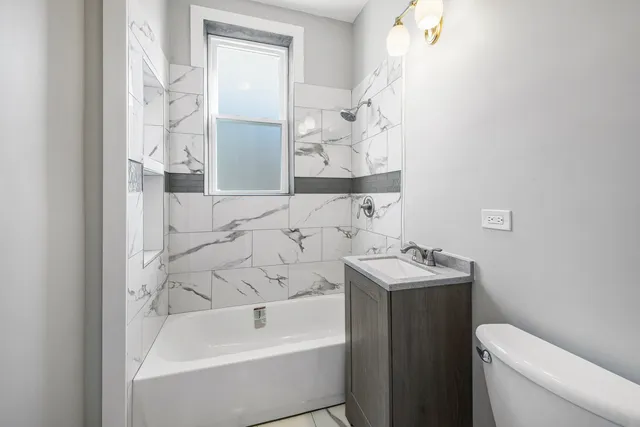 a bathroom with a sink toilet and bathtub