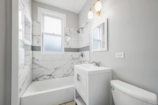 a bathroom with a sink toilet and bathtub