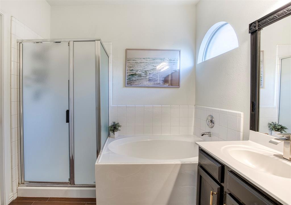 2805 Whetstone Drive Corinth, TX 76210 - Photo 21 of 38 a bathroom with a sink and a mirror