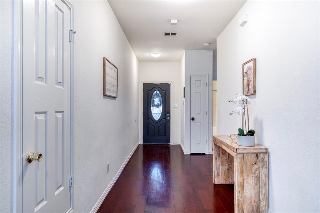2805 Whetstone Drive Corinth, TX 76210 - Photo 5 of 38 a view of a hallway with wooden floor and closet