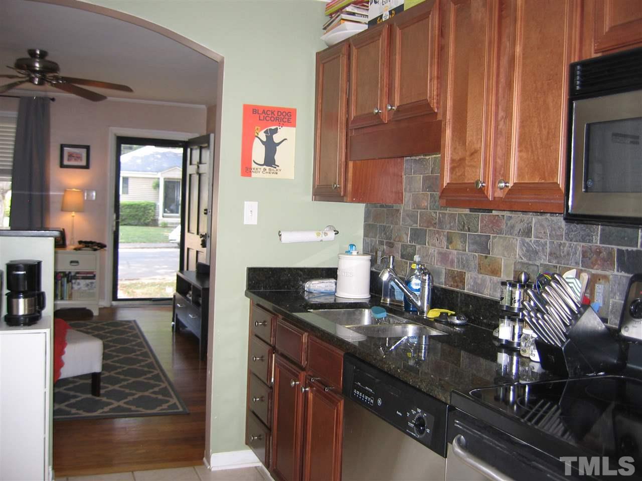 2331 Bernard Street, Unit 2331 Raleigh, NC 27608 - Photo 6 of 12 a kitchen with granite countertop a sink stove and cabinets