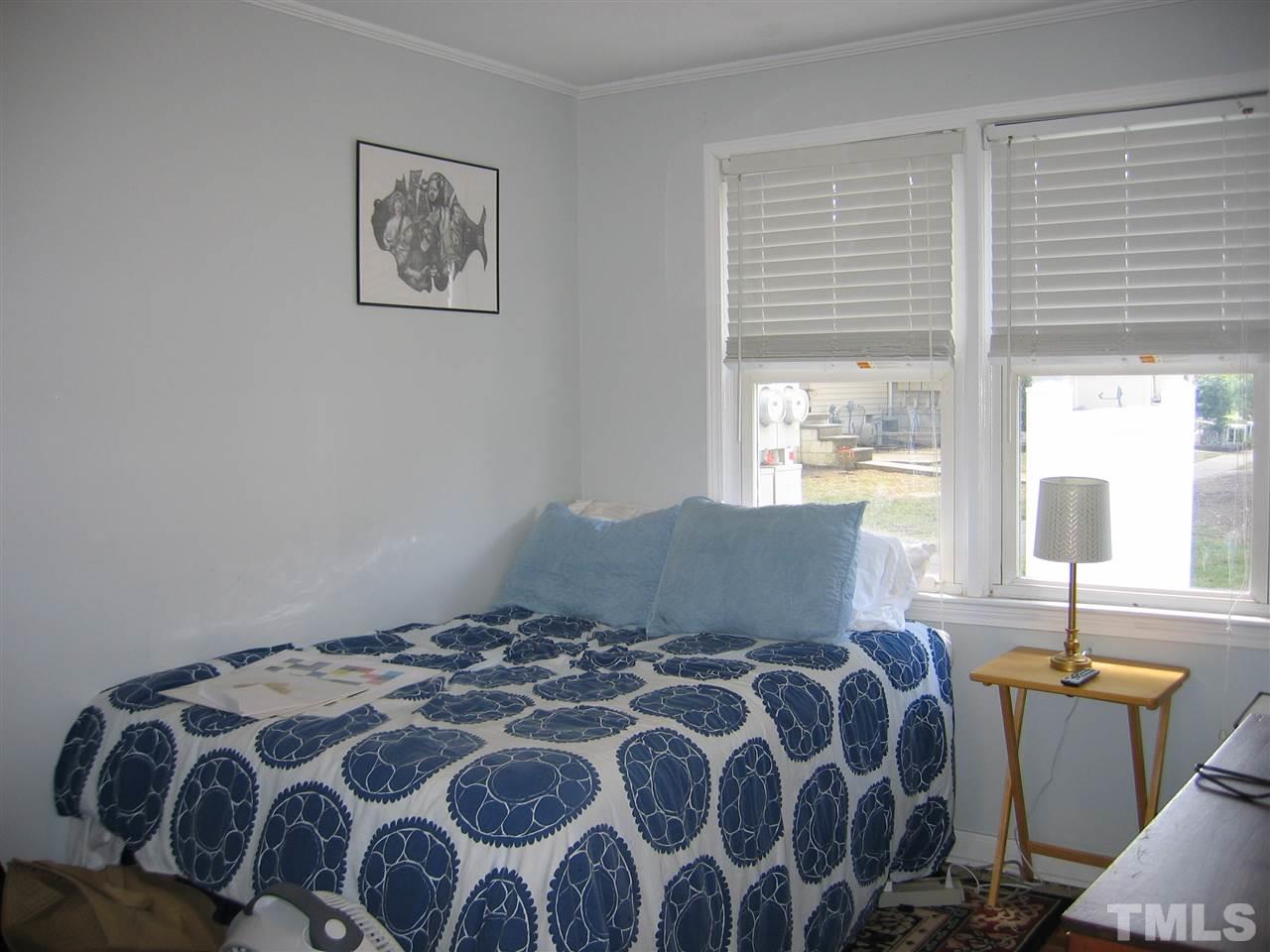 2331 Bernard Street, Unit 2331 Raleigh, NC 27608 - Photo 9 of 12 a bedroom with a bed and wooden floor