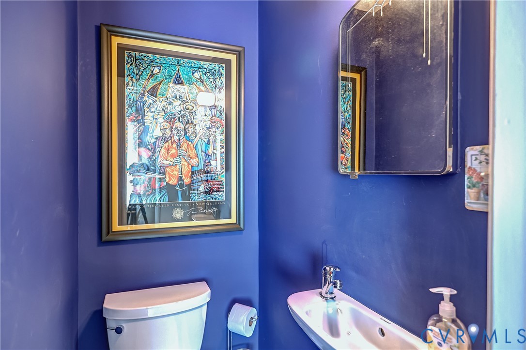 4814 Riverside Drive Richmond, VA 23225 - Photo 20 of 39 a bathroom with a toilet sink and mirror