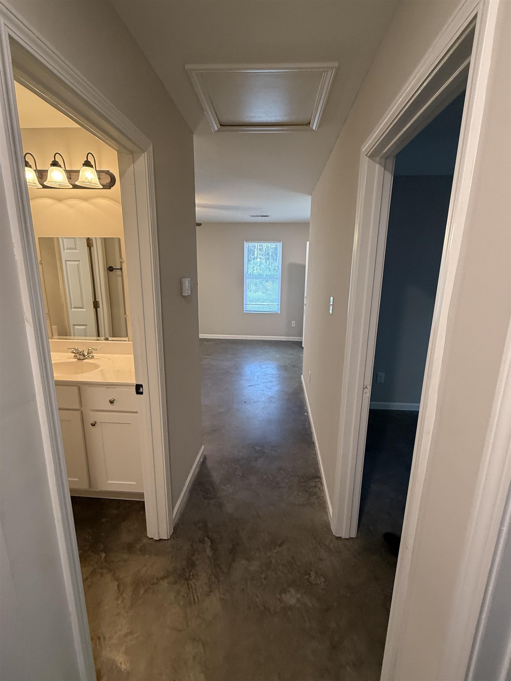 4589 Range Line Road Memphis, TN 38127 - Photo 20 of 25 Hallway with concrete floors and attic access