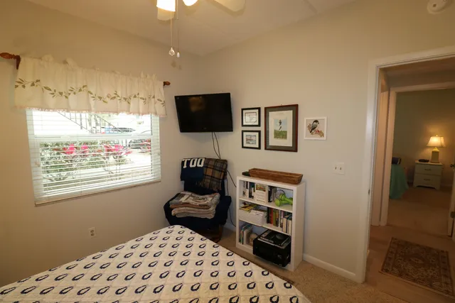 a bedroom with furniture and a flat screen tv