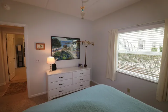 a bedroom with a bed and a dresser in it