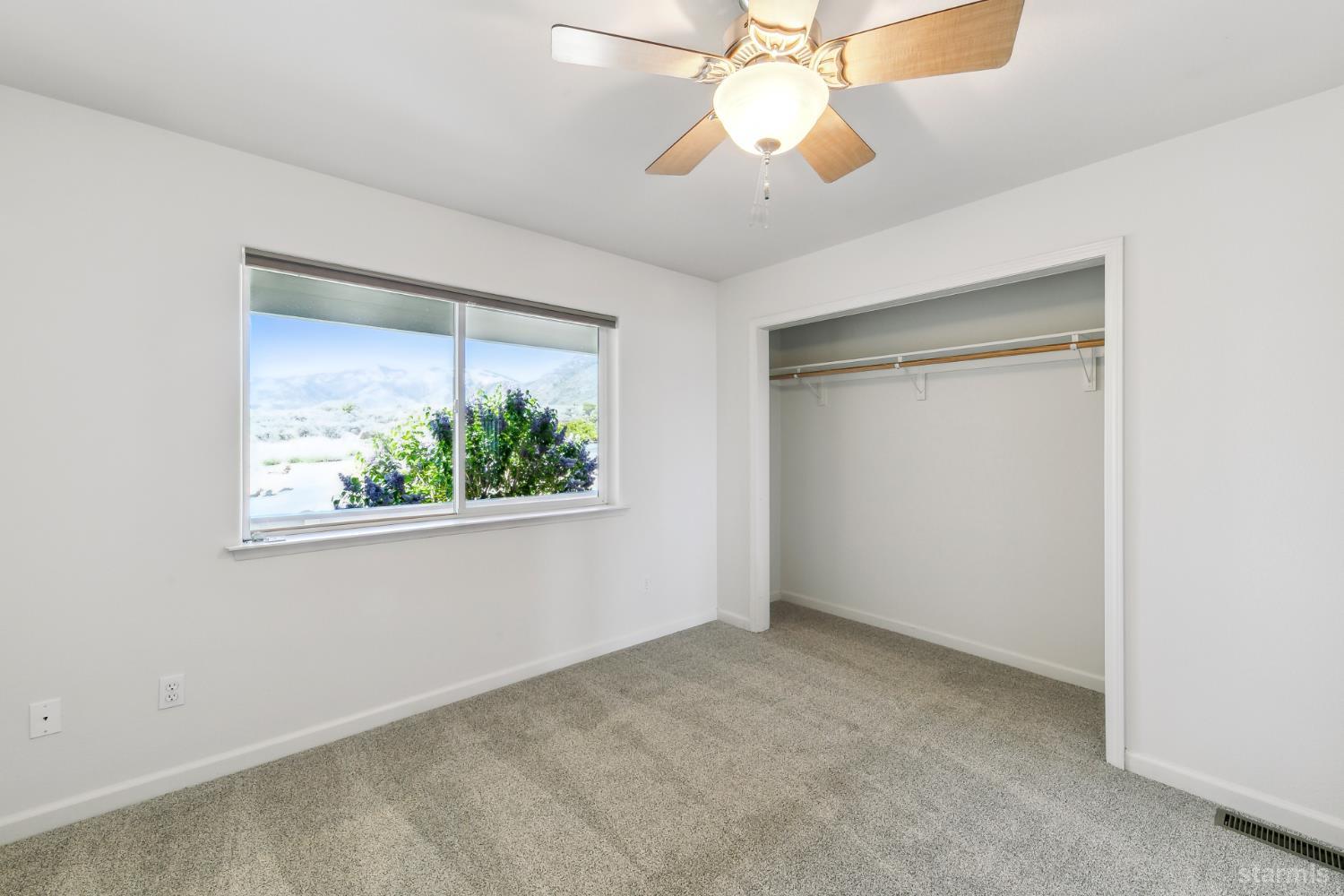 705 Sunrise Trail Markleeville, CA 96120 - Photo 19 of 39 an empty room with a window and a ceiling fan