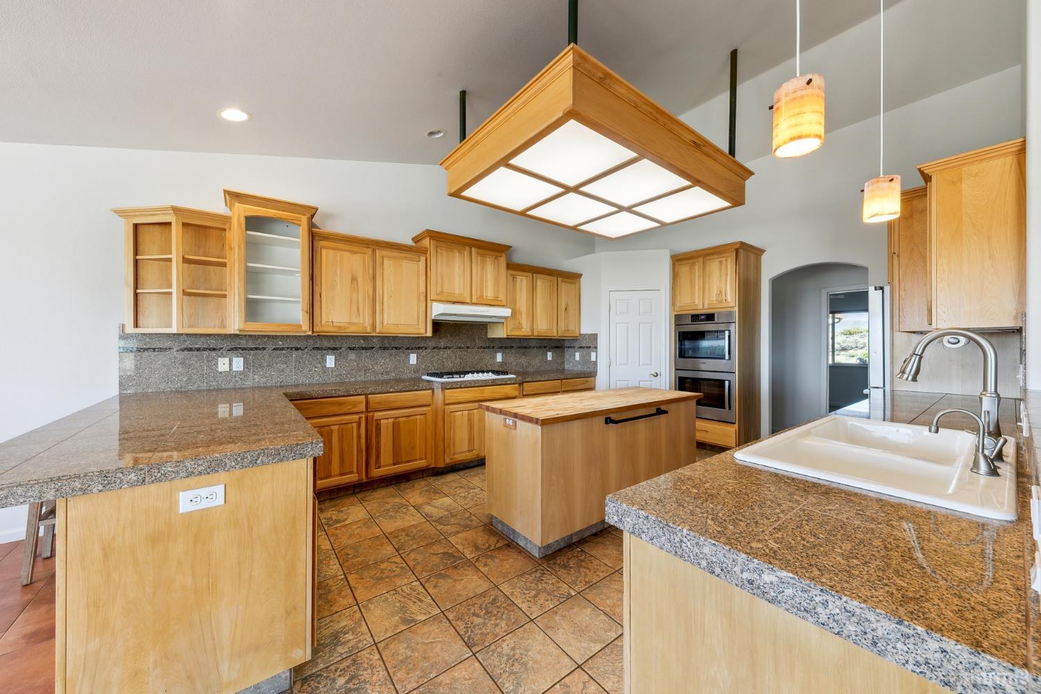 705 Sunrise Trail Markleeville, CA 96120 - Photo 8 of 39 a large kitchen with granite countertop a sink a counter top space and stainless steel appliances