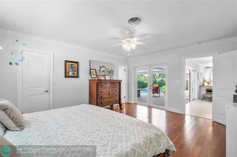 2932 Northeast 36th Street Lighthouse Point, FL 33064 - Photo 12 of 31 a bedroom with a bed dresser and wooden floor