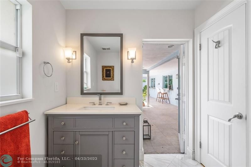2932 Northeast 36th Street Lighthouse Point, FL 33064 - Photo 13 of 31 a bathroom with a sink vanity and mirror