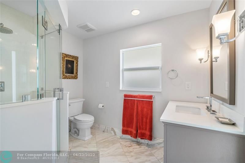 2932 Northeast 36th Street Lighthouse Point, FL 33064 - Photo 14 of 31 a bathroom with a toilet sink and mirror
