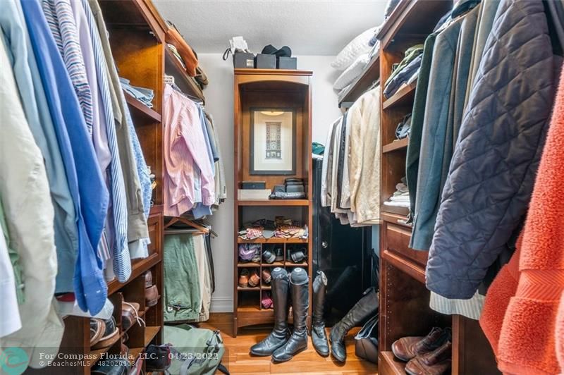 2932 Northeast 36th Street Lighthouse Point, FL 33064 - Photo 15 of 31 a view of walk in closet with clothes and shoes