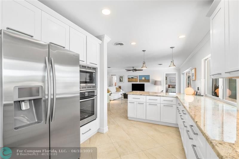 2932 Northeast 36th Street Lighthouse Point, FL 33064 - Photo 4 of 31 a kitchen with stainless steel appliances a refrigerator sink and microwave
