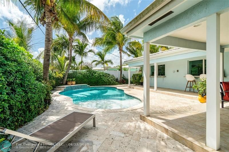 2932 Northeast 36th Street Lighthouse Point, FL 33064 - Photo 8 of 31 a view of a white house with a yard and potted plants