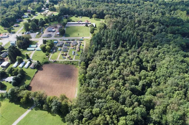 an aerial view of a house with a yard and garden