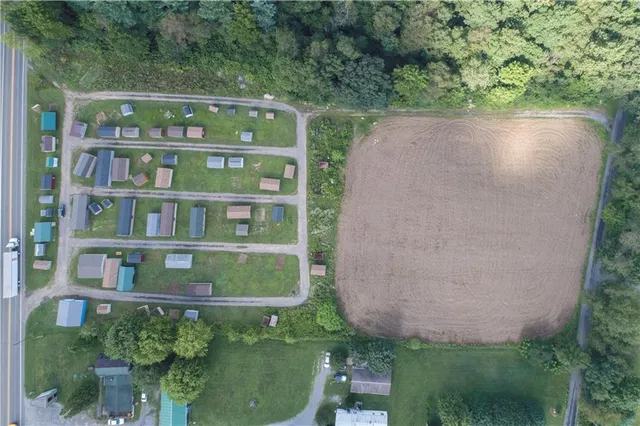an aerial view of residential house with outdoor space and swimming pool