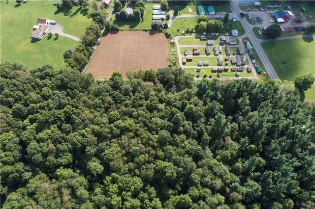 an aerial view of a residential houses with outdoor space