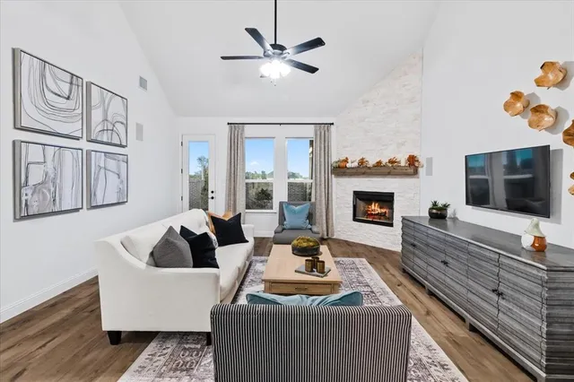 a living room with furniture fireplace and flat screen tv
