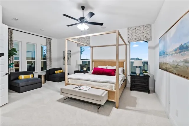 a bedroom with a bed couch and a chandelier