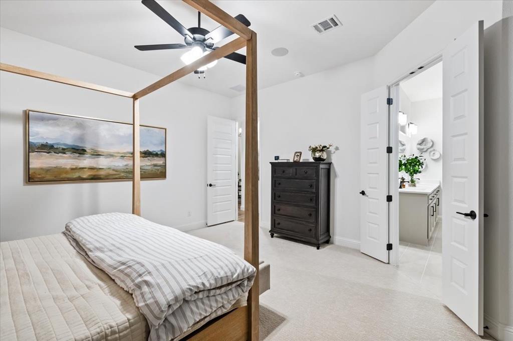 1210 Terrain Road Midlothian, TX 76065 - Photo 14 of 39 a bedroom with a bed and a chandelier