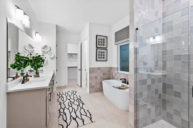 a bathroom with a sink and mirror with shower
