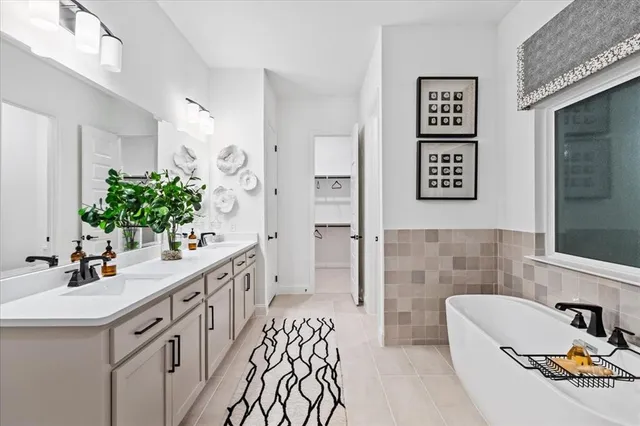 a bathroom with a sink a faucet a mirror and a shower