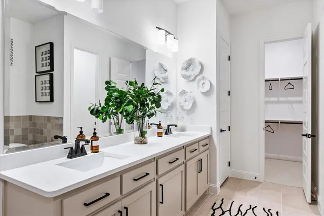 a bathroom with a double vanity sink a mirror and a shower