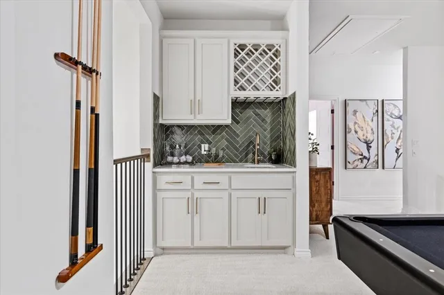 a kitchen with white cabinets and a stove