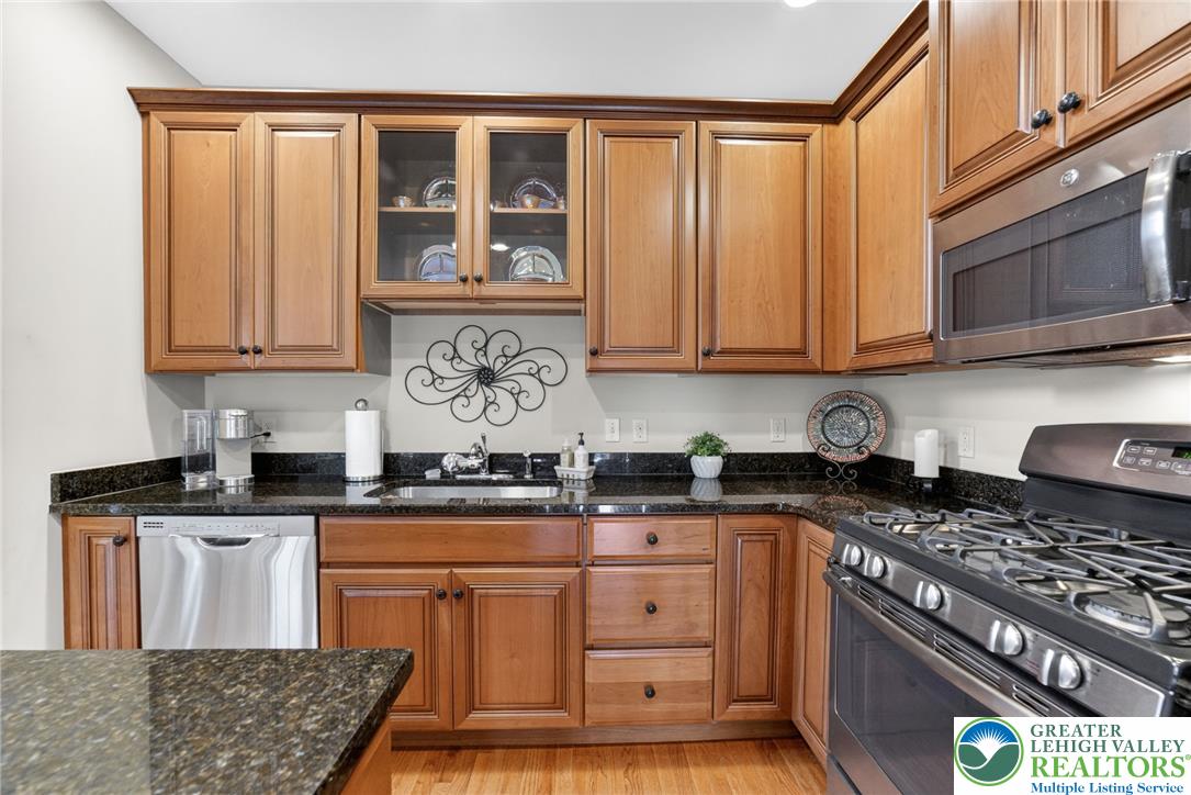 5440 Spring Ridge Drive West Macungie, PA 18062 - Photo 9 of 40 Rich wood cabinetry and granite countertops complete this well-appointed kitchen.