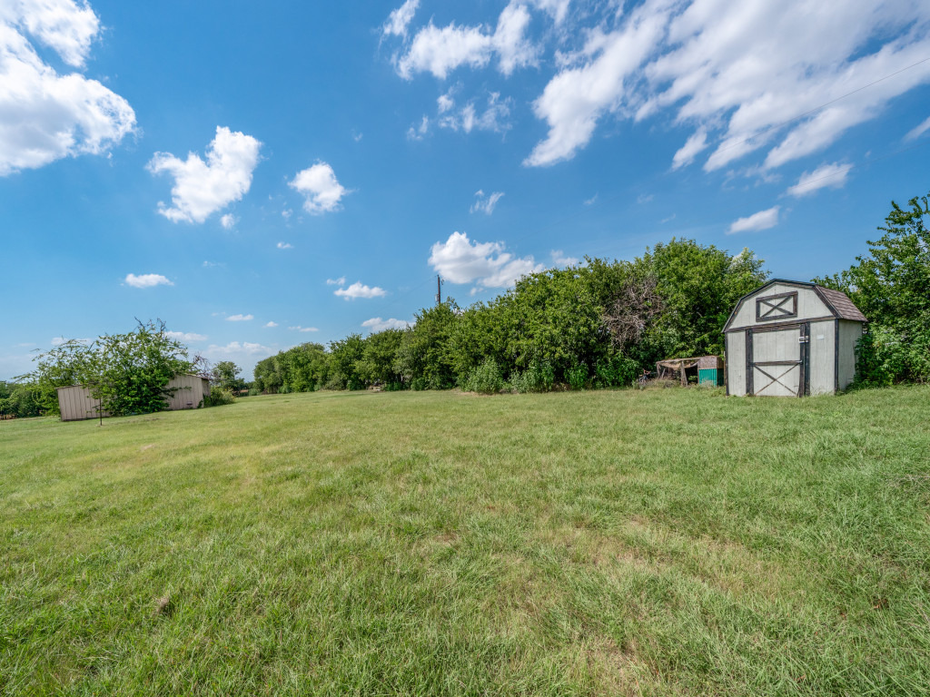 4654 Old Howard Road Temple, TX 76504 - Photo 21 of 25 A spacious, verdant yard features a charming barn and ample room for outdoor activities.