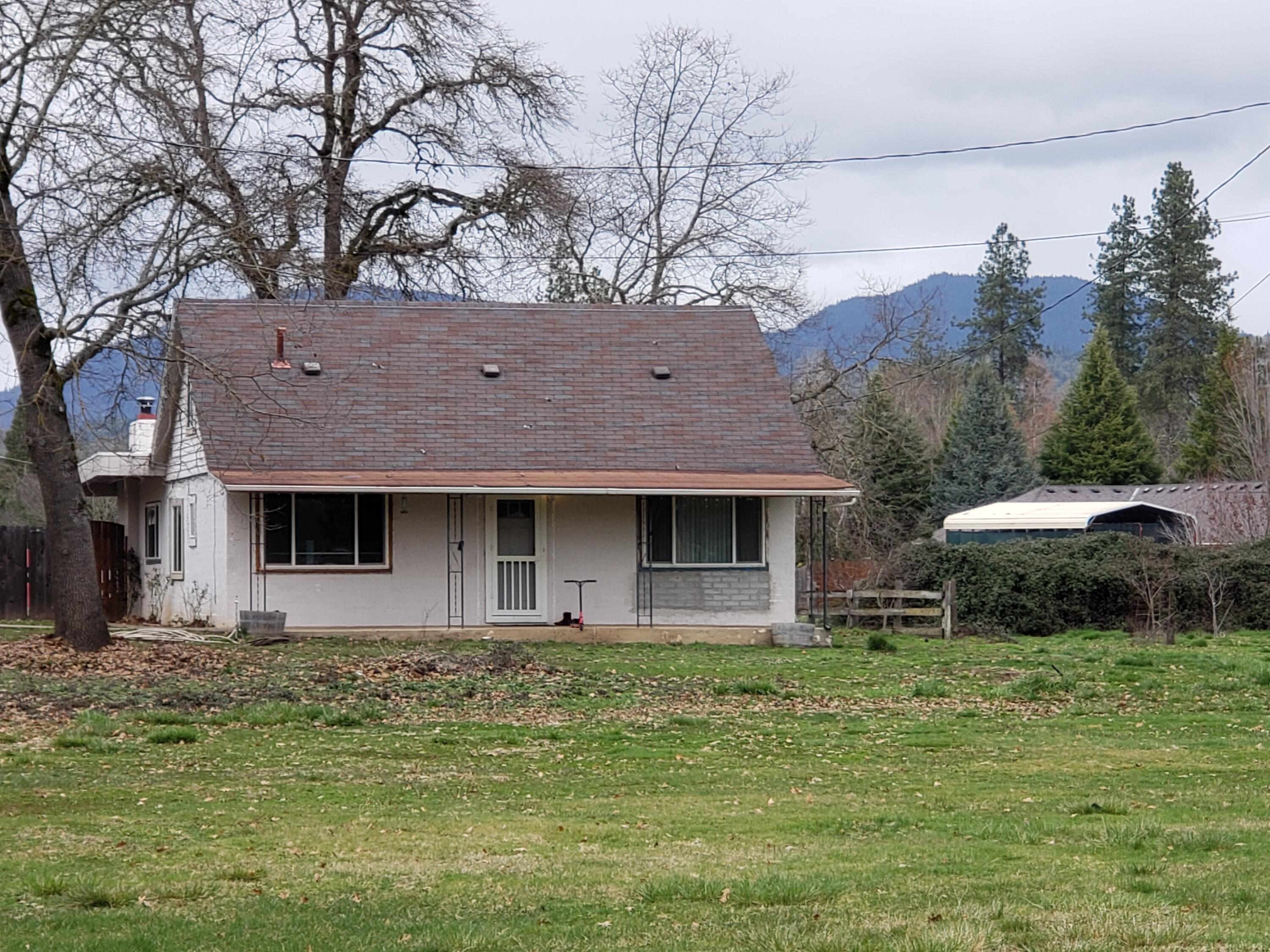 2850 South River Road Grants Pass, OR 97527 - Photo 1 of 26 a front view of a house with garden