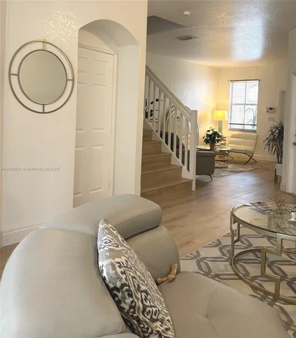 a living room with furniture and a large window