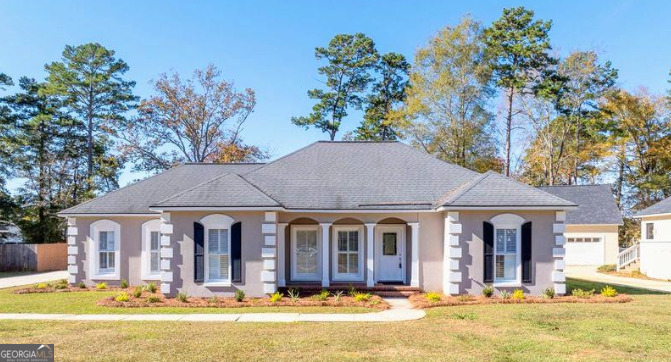 a front view of a house with a yard