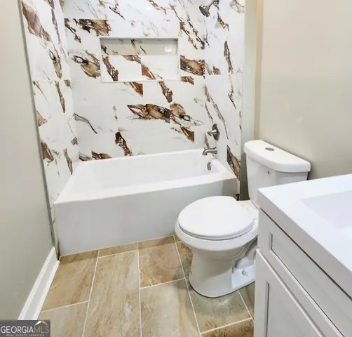 a bathroom with a toilet and a tub