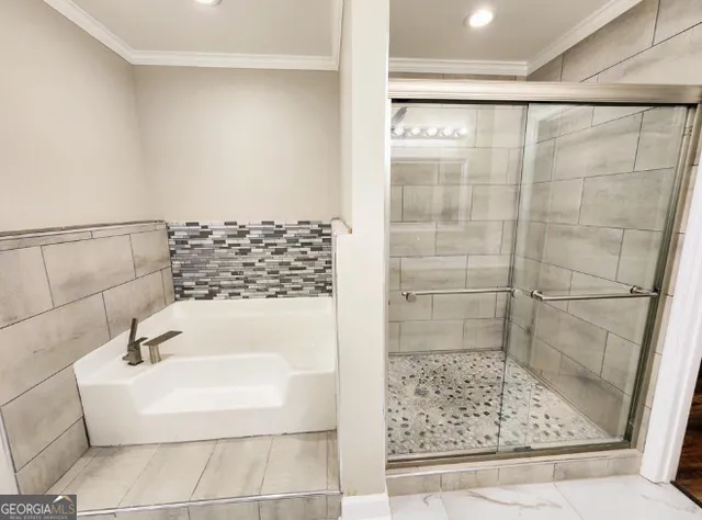 a bathroom with a bathtub and shower