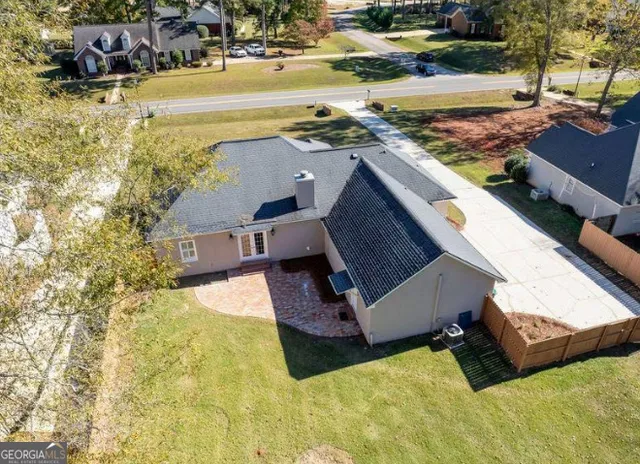 an aerial view of residential houses with outdoor space