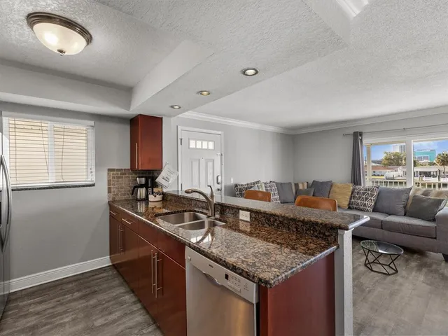 a bedroom with a large bed and wooden floor