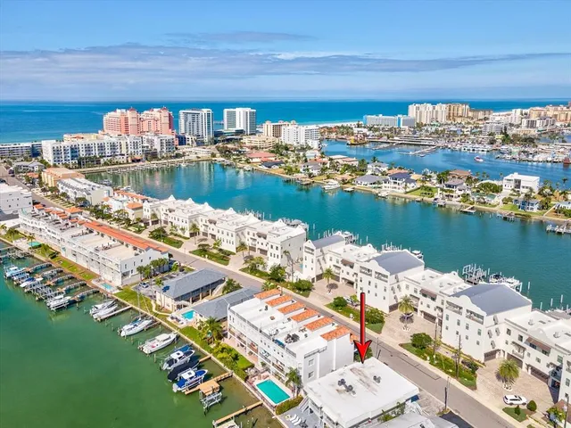 an aerial view of a house with outdoor space lake view and ocean view