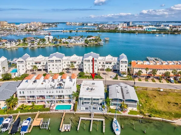 an aerial view of a house with a garden and lake view