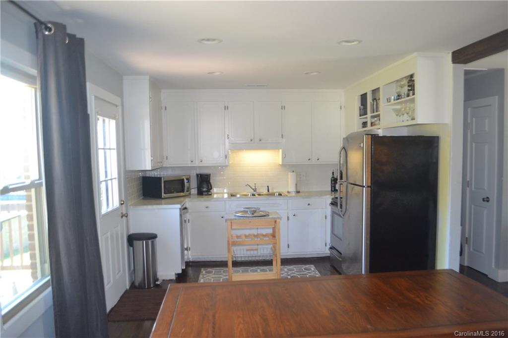 3233 Smith Farm Road Matthews, NC 28104 - Photo 3 of 23 a kitchen with stainless steel appliances granite countertop a refrigerator a stove and a window