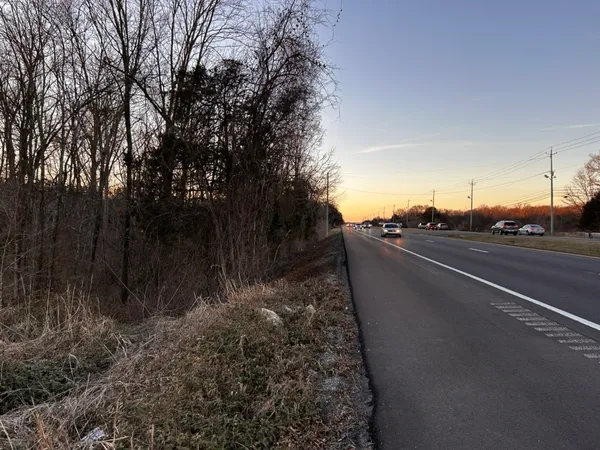 a view of a street with trees on both side of it